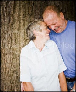 Couple laughing against a tree - Portrait & Family Photographer