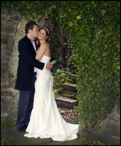 Bride and Groom in a stone archway - Wedding Photographer