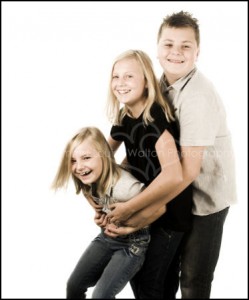 Three kids hugging smiling and laughing - Family & Portrait Photographer