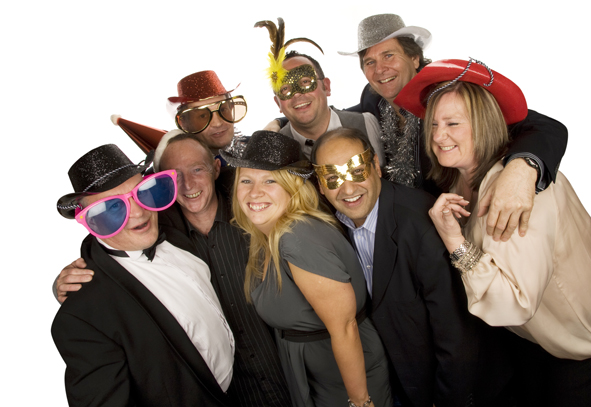 Another Photobooth Hire shot from Emma-Louise Walton Photography in Burnham. Eight adults smiling and posing for a group photo wearing a variety of photobooth props including oversized sunglasses, cowboy hats and masks