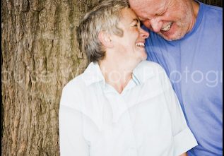 Couple laughing against a tree for portrait photographer from Burnham, Slough